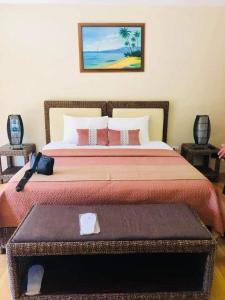 a bedroom with a large bed with a table at Infinity Sands Resort in Siquijor