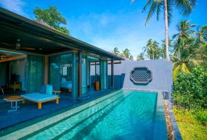 a villa with a swimming pool and a house at Baba Beach Club Natai Luxury Pool Villa Hotel by Sri panwa - SHA Plus in Natai Beach