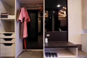 a walk in closet with a black counter and a mirror at Baba Beach Club Natai Luxury Pool Villa Hotel by Sri panwa - SHA Plus in Natai Beach