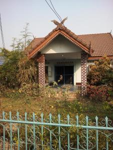 a house with a fence in front of it at Tent KONOK in Ban Huai Dua