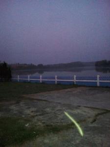 a fence next to a large body of water at Tent KONOK in Ban Huai Dua