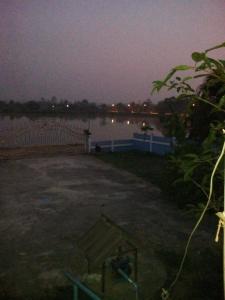 a parking lot next to a body of water at night at Tent KONOK in Ban Huai Dua