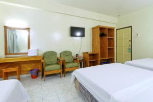 a bedroom with two beds and a desk and a computer at Nan Yeang Hotel in Kuala Lumpur