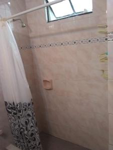a shower with a shower curtain in a bathroom at Laura in Rosario