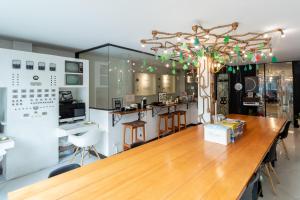 a kitchen with a large wooden table and chairs at The Secret Service Bed & Breakfast in Bangkok