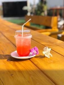 a drink on a plate on a wooden table at A.K. Terrace Hotel in Sara Buri