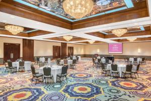 a banquet hall with tables and chairs and a stage at Crowne Plaza Hotel Hickory by IHG in Hickory