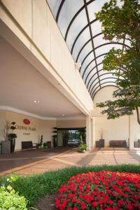 a building with a glass ceiling with red flowers at Crowne Plaza Hotel Hickory, an IHG Hotel in Hickory