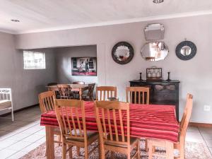 a dining room with a table and chairs at Pennygum Country Cottages in Underberg