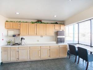 a kitchen with wooden cabinets and a counter top at Budgetlodge in Oklahoma City