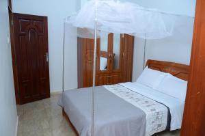 a bedroom with a bed with a canopy at Muyenga Luxury Vacation Home in Kampala