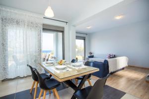 a living room with a dining room table and chairs at Rhodes Sea Villas in Ixia