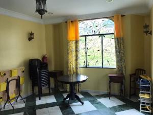 a room with a table and a window at Golden Hill in Cameron Highlands