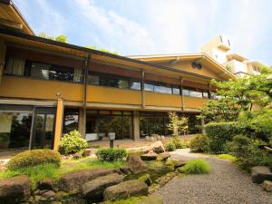 a large stone building with a view of the ocean at Hotel Nagaragawa No Sato in Gifu
