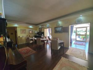 a living room with tables and chairs and a dining room at Villa la Quercia Resort in San Salvatore Telesino