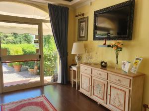 a living room with a large television on the wall at Villa la Quercia Resort in San Salvatore Telesino