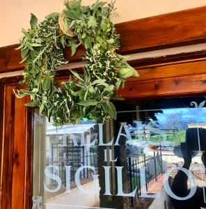 a bunch of plants hanging over a window at Locanda Il Sigillo B&B e Ristorante in Rosignano Marittimo