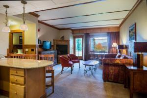 a living room with a couch and a table at Crowne Plaza Lake Placid by IHG in Lake Placid