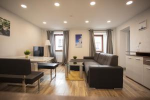 a living room with a couch and a table at Modern Old Town Apartment in Hall in Tirol