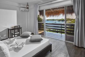 a bedroom with a bed with a view of the water at Blanco Beach Resort Malapascua in Malapascua Island