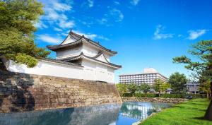a building on a wall next to a river at ANA Crowne Plaza Hotel Kyoto by IHG in Kyoto