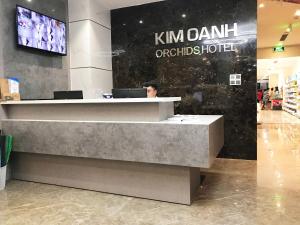 a man sitting at a counter in a store at Kim Oanh Orchids Hotel in Da Lat