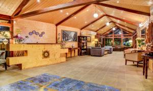 a large living room with wooden walls and wooden ceiling at Treebo Tryst Blue Mountain Country Club And Resort in Siliguri