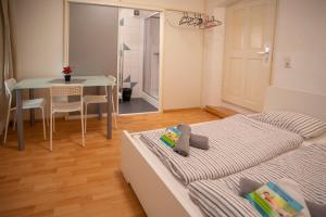 a bedroom with two beds and a table and a dining room at Nice Old Town Apartment in Hall in Tirol