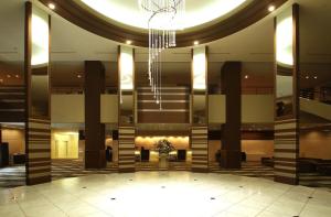 a lobby with a chandelier in a building at ANA Crowne Plaza Hotel Kushiro by IHG in Kushiro