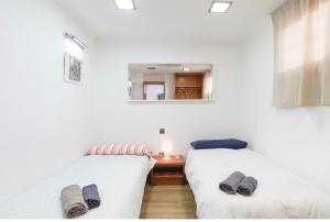 Postel nebo postele na pokoji v ubytování Ílios Soho Apartamentos
