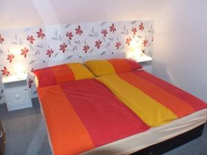 a bedroom with a bed with a colorful blanket at Katalin nyaraló in Balatonkeresztúr