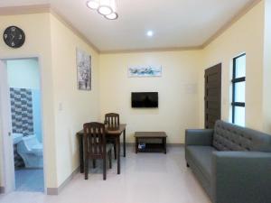 a living room with a couch and a table at Mifaña Suites - Panglao Island in Dauis