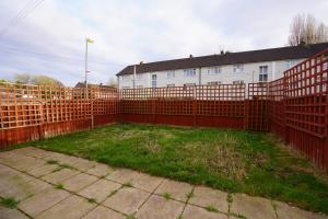 a fence in front of a house with a yard at Birmingham BHX-HS2 -NEC APARTMENT in Birmingham