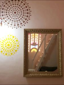 a mirror in a room with a staircase and a chandelier at Mandala in Bari