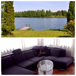 a black couch sitting in front of a lake at Ferienpark Tannenbruchsee in Neustadt am Rübenberge