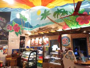 a restaurant with a colorful ceiling in a store at Gabby's Bed & Breakfast in Dumaguete