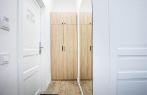 a closet with wooden cabinets in a room at Partner Guest House Khreschatyk in Kyiv