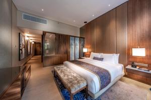 a large bedroom with a large bed and wooden walls at Hard Rock Hotel Desaru Coast in Desaru