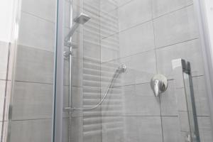 a shower with a glass door in a bathroom at Casa Lyon in Potenza