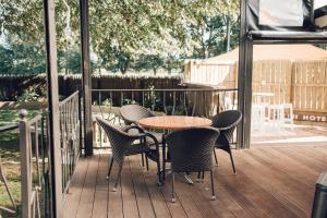 a patio with a table and chairs on a deck at Makikihi Country Hotel in Waimate