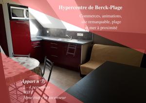 a kitchen with a sink and a table with a tableablish at Studio avec mezzanine Berck-Plage Hyper-centre in Berck-sur-Mer