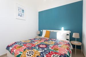 a bedroom with a large bed with a colorful bedspread at Casa Lyon in Potenza