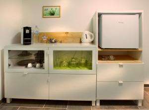 a kitchen with white cabinets and a refrigerator at elli's in Schwabach