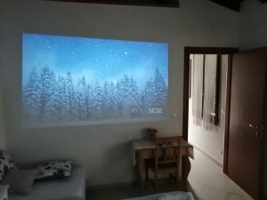 a living room with a picture of a forest at Borgo Foce La Spezia SP2389 in La Foce