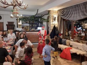 a group of people in a living room with santa at Horlog Castle in Trigrad