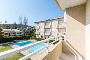 a view of the pool from the balcony of a building at Vilar - Xiprer in El Port