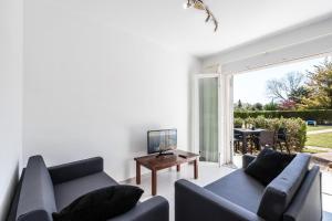 a living room with two couches and a table at Vilar - Xiprer in El Port