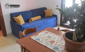 A seating area at Residence Marina di Carlino Tourist