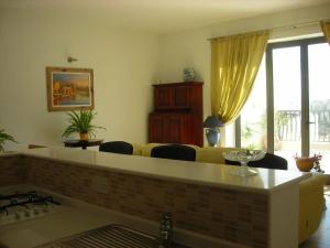 a living room with a yellow couch and chairs at Apartment in Marsaskala in Marsaskala