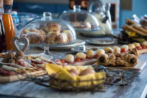 a buffet of food on a table with plates of food at 7cento Vesuviano in Ercolano